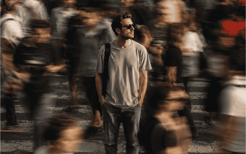Man standing still in fast moving crowd
